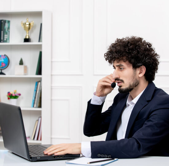 customer-service-handsome-curly-man-office-suit-with-computer-headset-from-side